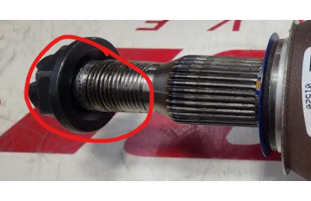 The damage caused to a wheel drive shaft nut when removed using power equipment