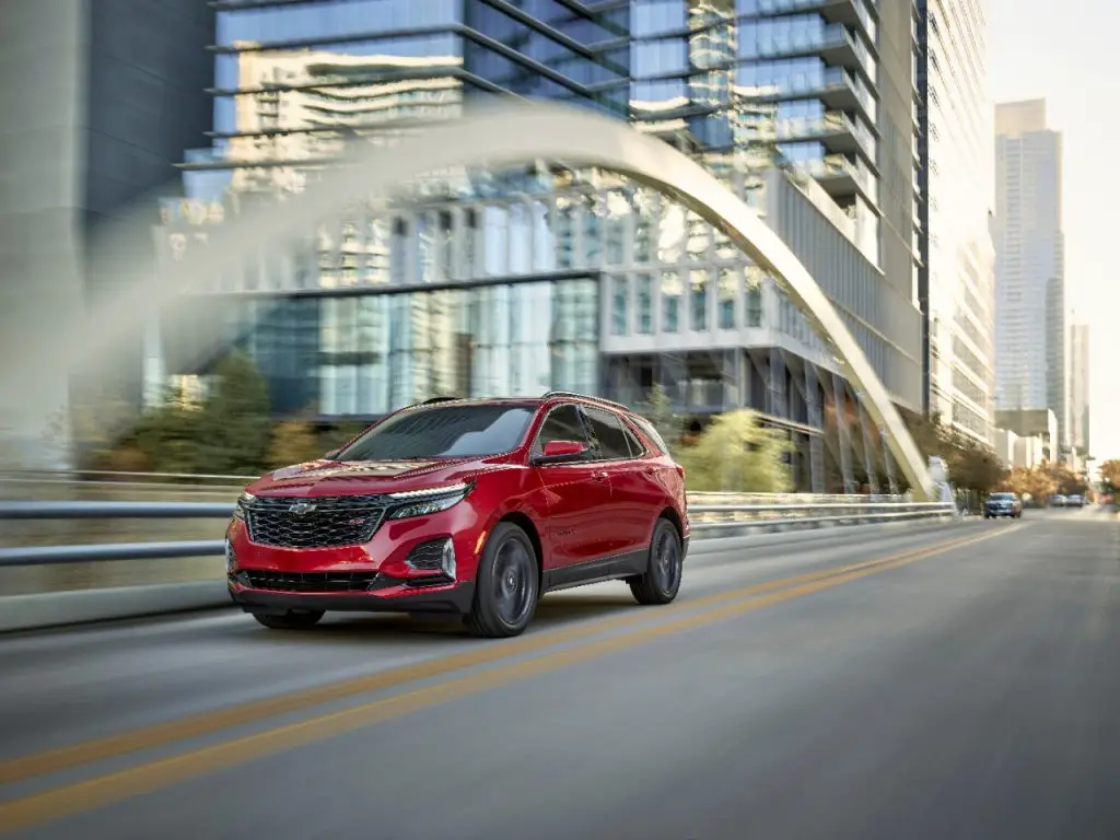 A red 2024 Chevrolet Equinox traveling over a bridge