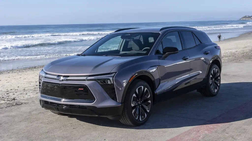 A Chevrolet Blazer EV in  Iridescent Pearl Tricoat parked next to the pacific ocean