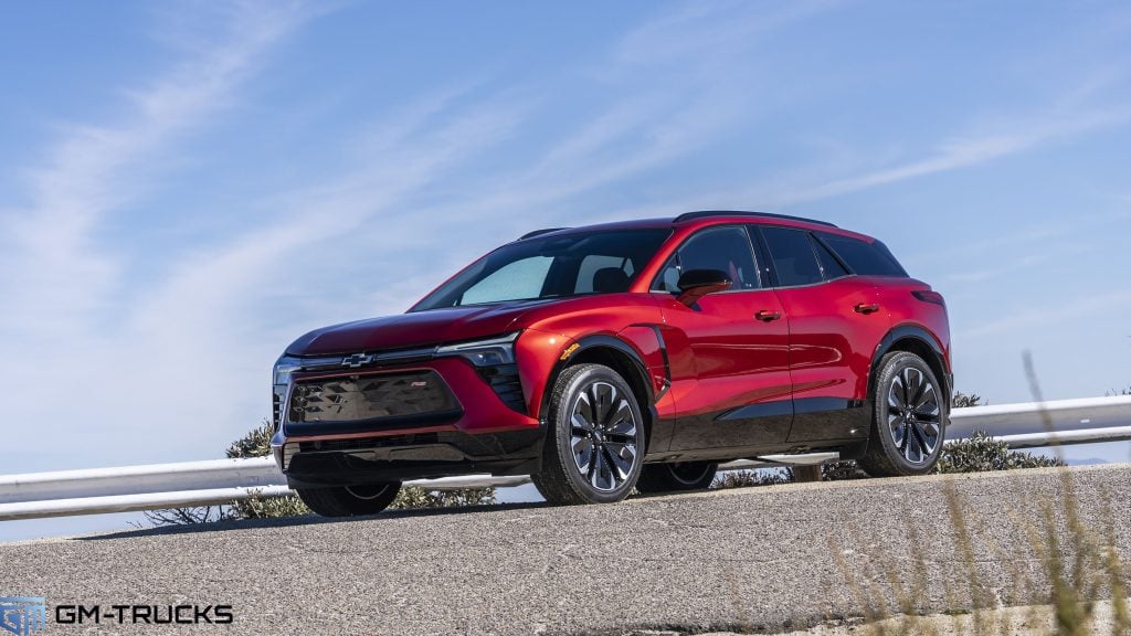 A red Blazer EV parked on a scenic overlook