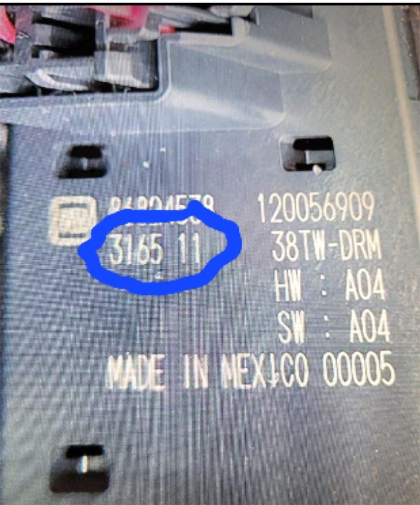 A window switch from a Chevrolet Colorado, GMC Canyon or Chevy Blazer EV with the date code circled