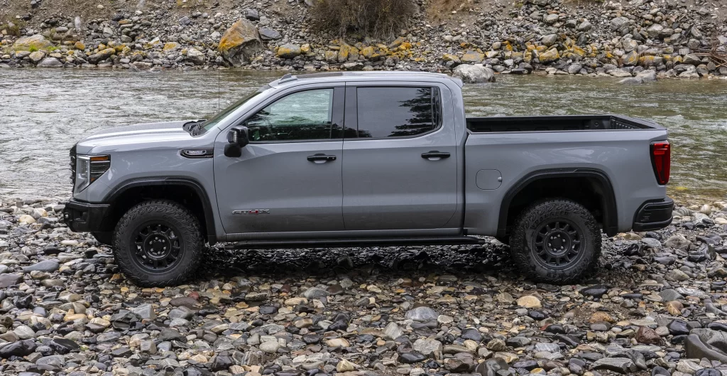 A Sierra 1500 AT4X AEV Edition on a stream bed. You can see the rocker protection under the doors. 