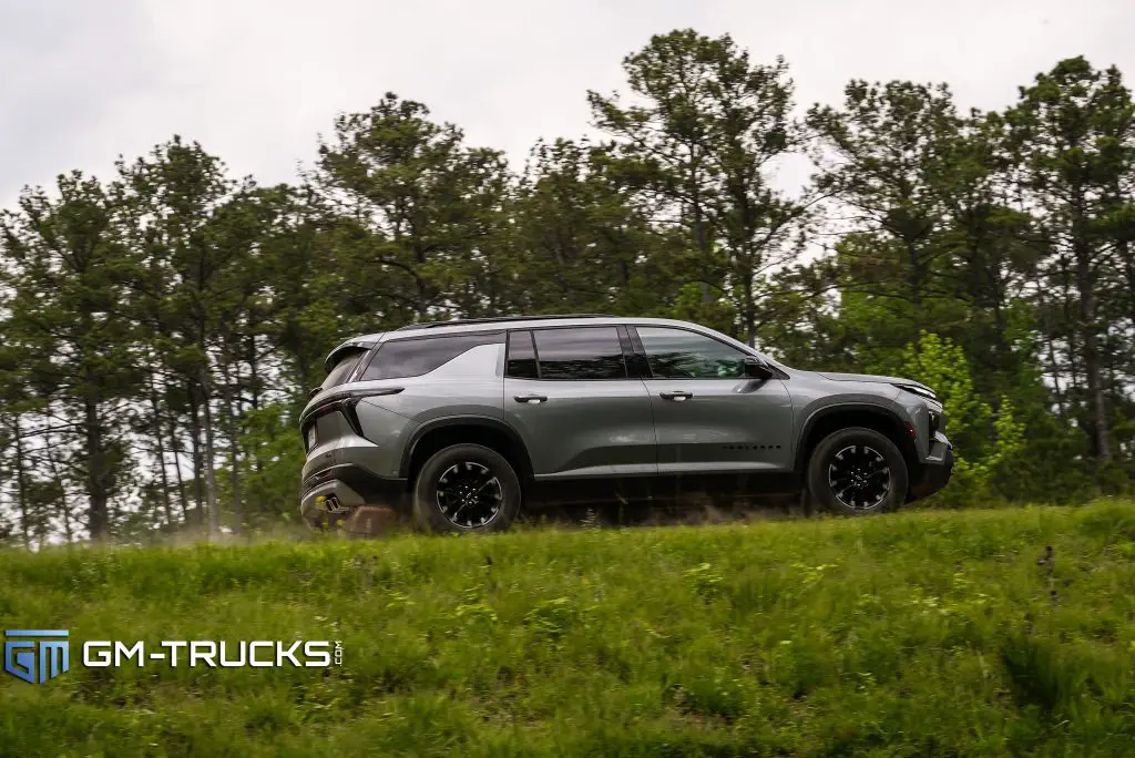 The 2024 Chevrolet Traverse crossing a pond dam, photographed from a lower view