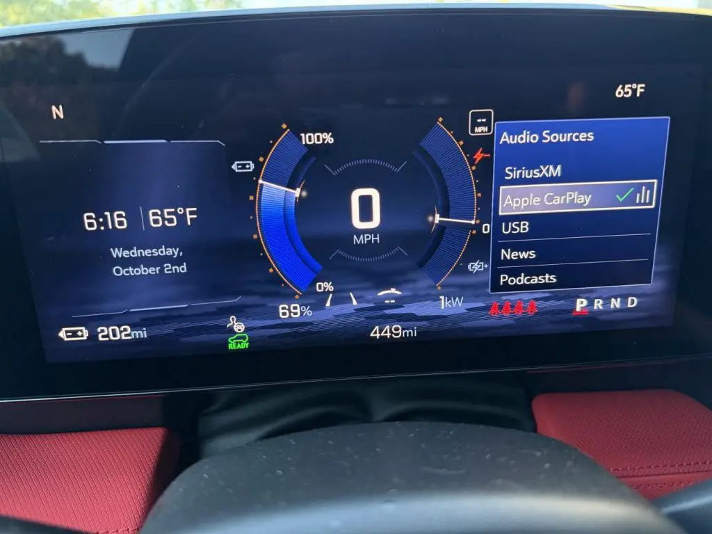 Chevrolet Blazer EV digital gauge cluster showing Apple CarPlay as an available audio source with battery status and range displayed.