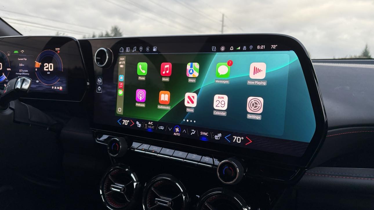 Chevrolet EV dashboard showing Apple CarPlay interface on the infotainment screen with climate controls and a digital instrument cluster in view.